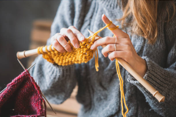Hands crocheting with yarn
